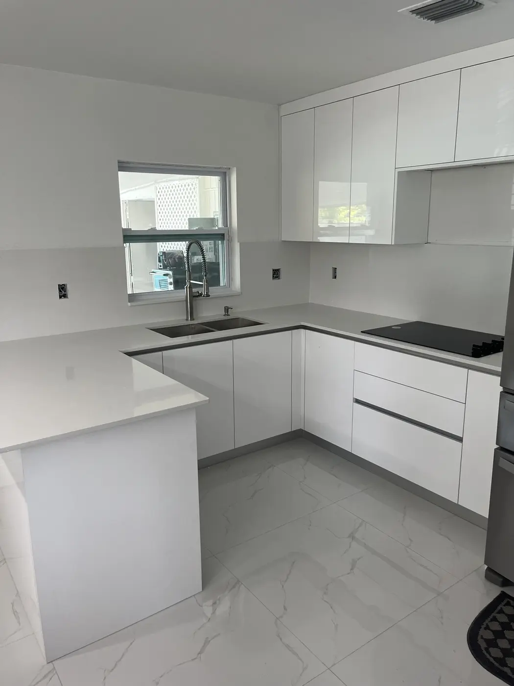 Minimal white kitchen with custom stone countertops